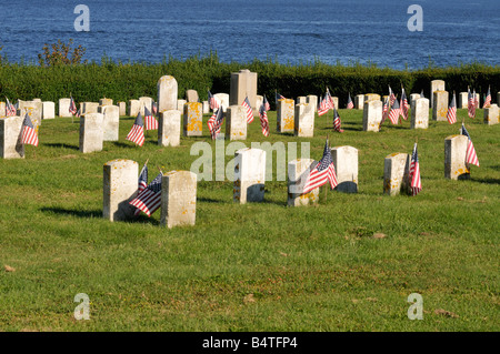 Historic cemetery with American flags in Fort Adams State Park Newport, Rhode Island with Pell  Bridge & ocean USA Stock Photo