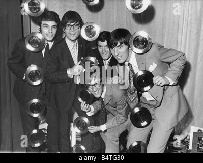 Cliff Richard and the Shadows celebrate their tenth anniversary Cliff Richard and the Shadows surrounded by Golden Discs at todays celebration party in London They are left to right John Rostill Cliff Richard Hank B Marvin front and Glasses Brian Bennett and Bruce Welch Stock Photo