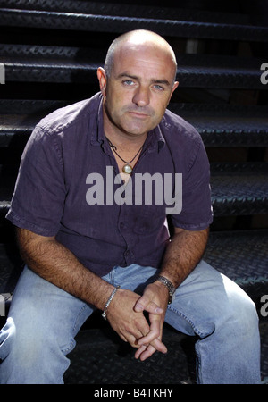 The Bill Actor Bruce Byron September 2004 In London Sitting on steps Mirrorpix Stock Photo