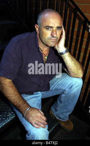 The Bill Actor Bruce Byron September 2004 In London Sitting on steps Mirrorpix Stock Photo