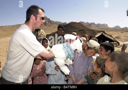 Actor Neil Morrissey pictured in Afghanistan with the No Strings charity teaching mine awareness to children using puppets June Stock Photo