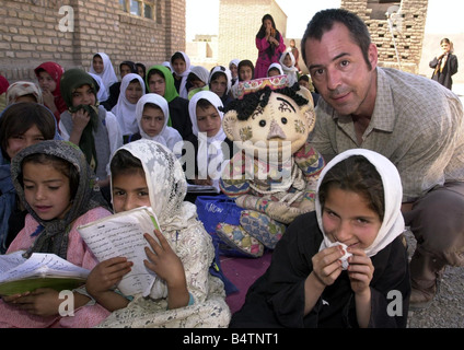 Actor Neil Morrissey pictured in Afghanistan with the No Strings charity teaching mine awareness to children using puppets June Stock Photo