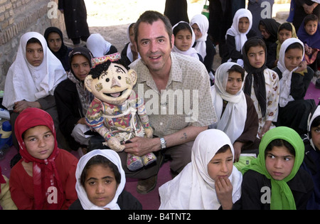 Actor Neil Morrissey pictured in Afghanistan with the No Strings charity teaching mine awareness to children using puppets June Stock Photo