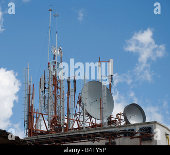 Group of telecommunication antennas installed on the top of a building Stock Photo