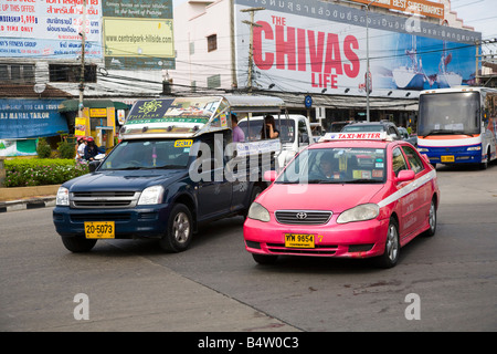 traditional “Tuktuk” taxis, Shared Mobile open-air, passenger vehicle, Baht Bus, Songthaew, Tuk-Tuk, or Taxi,  Advertising Pattaya, Thailand. Stock Photo