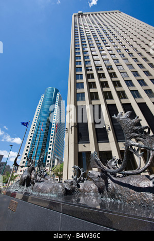 Bronze sculpture of caribous crossing river, outside the Richardson Building with the Canwest Place building