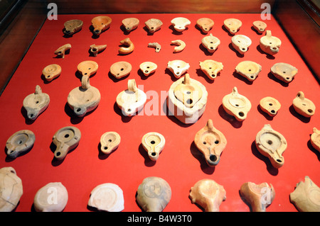 A display of oil lamps made of clay National Museum of Roman Art Merida Extremadura Spain Stock Photo