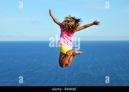 Flying girl against the sea Stock Photo