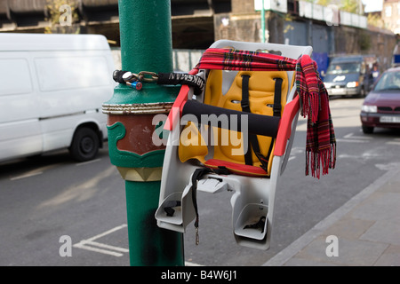 Childs Bicycle Seat Locked to Lamp Post Stock Photo