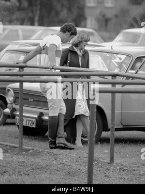 Prince Charles leans back on to railings as he chats with Camilla Parker Bowles during a break in a polo game at Windsor Great Park Royal Prince of Wales Sport Girlfriend June1975 1970s Mirrorpix Stock Photo