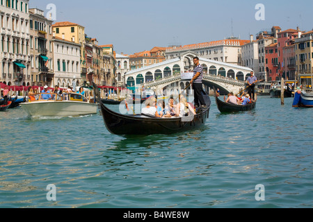 Taking a Gondola ride near the Rialto Bridge in Venice Italy Stock Photo