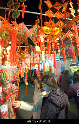 A stall selling Chinese New Year decorations for the year of the Rooster at the Temple street market in Hong Kong. Stock Photo