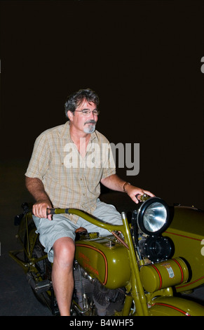 Man riding vintage motorcycle Stock Photo