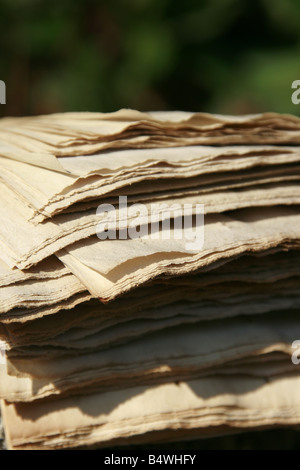 pile of old faded newspapers outdoors in sun Stock Photo