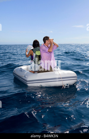 Couple lost at sea on little boat Stock Photo
