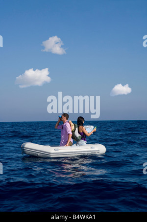 Couple lost at sea on little boat Stock Photo
