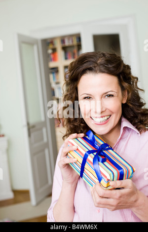 Woman happy about her birthday present Stock Photo