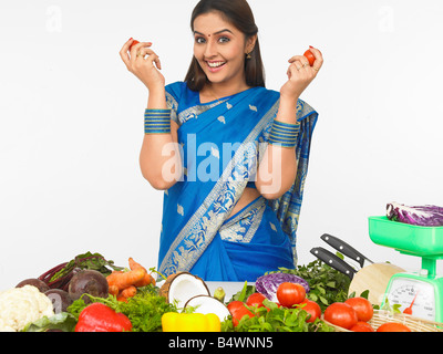 asian women of indian origin with her vegetables kitchen Stock Photo