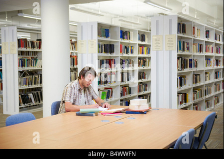 Young man working in library Stock Photo