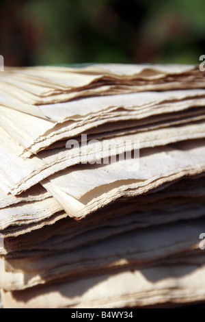 pile of old faded newspapers outdoors in sun Stock Photo