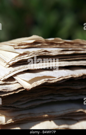 pile of old faded newspapers outdoors in sun Stock Photo