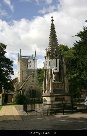 City of Gloucester, England. The Bishop Hooper Monument with the St Mary De Lode Church in the background.