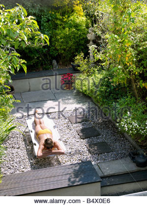 Woman sunbathing in patio chair Stock Photo: 61887020 - Alamy