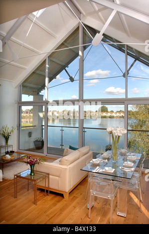 A CONTEMPORARY LIVING ROOM WITH A DINING AREA IN A WATERSIDE APPARTMENT AT THE LOWER MILL ESTATE NEAR CIRENCESTER GLOUCESTERSHIR Stock Photo