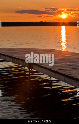 Sunset over a wooden wharf on Lake Audy, Riding Mountain National Park, Manitoba, Canada Stock Photo