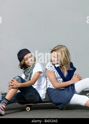Two kids on a skateboard Stock Photo