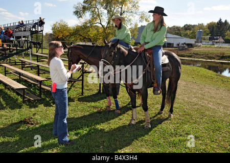 High school girls are interviewed for newspaper for rodeo competition Stock Photo