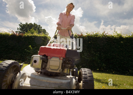 Man with push lawnmower, low angle