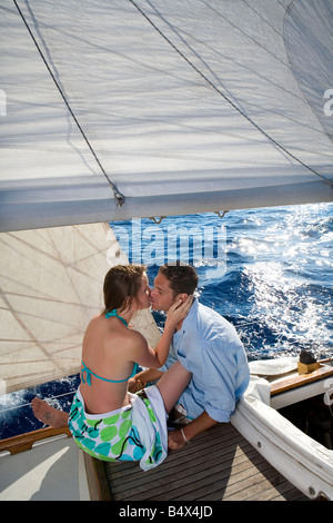 Couple kissing on sailboat Stock Photo