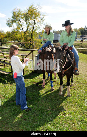 High school girls are interviewed for newspaper for rodeo competition Stock Photo