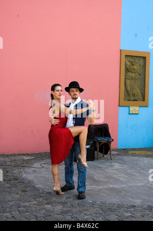 Street performers dancing the tango pose for a photo for a tourist in La Boca a famous neighbourhood in Buenos Aires Argentina Stock Photo