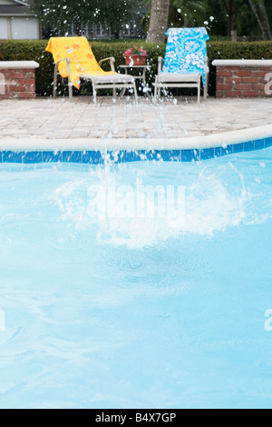 Big splash in swimming pool Stock Photo