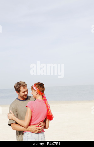 Couple hugging on beach Stock Photo