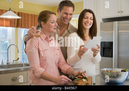 Friends looking at photographs at dinner party Stock Photo