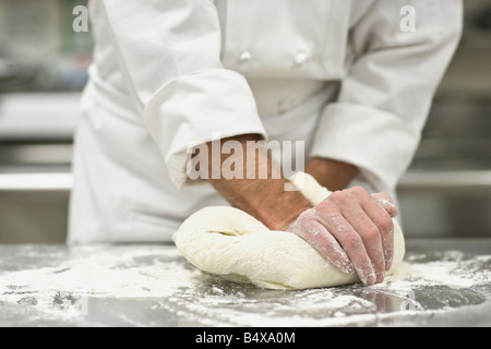 Baker kneading bread dough Stock Photo