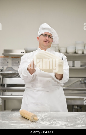 Chef stretching pizza dough Stock Photo
