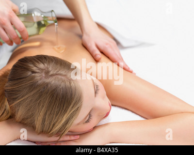 Young woman getting oil massage Stock Photo