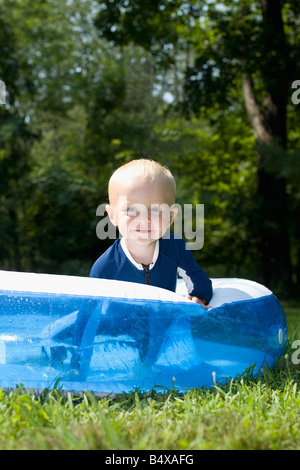 Baby boy playing in inflatable swimming pool Stock Photo