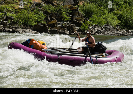 Man whitewater rafting Stock Photo