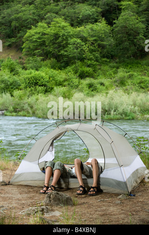 Couple relaxing in tent Stock Photo