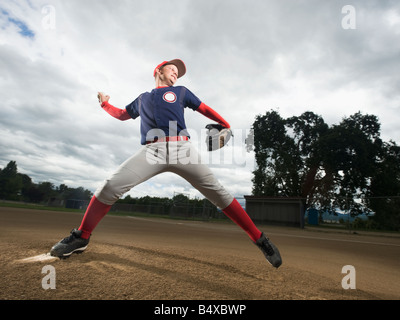 Baseball pitcher throwing ball Stock Photo