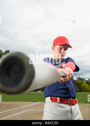 Baseball player swinging bat Stock Photo