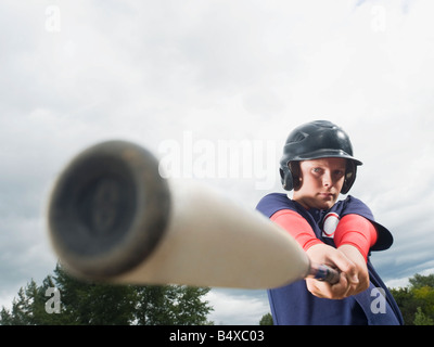 Baseball player swinging bat Stock Photo