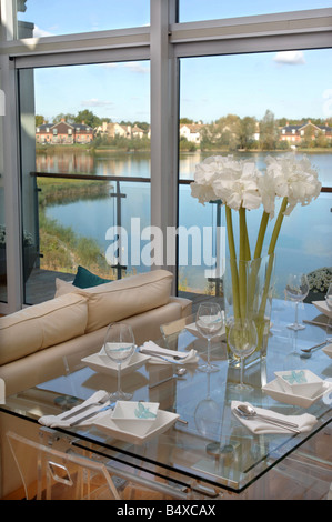 A CONTEMPORARY LIVING ROOM WITH A DINING AREA IN A WATERSIDE APPARTMENT AT THE LOWER MILL ESTATE NEAR CIRENCESTER GLOUCESTERSHIR Stock Photo