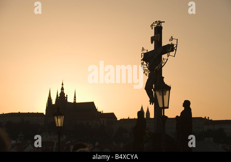 Silhouetted crucifix and cathedral Stock Photo