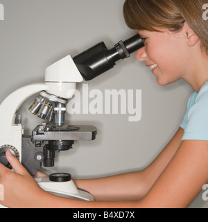 Girl using microscope Stock Photo